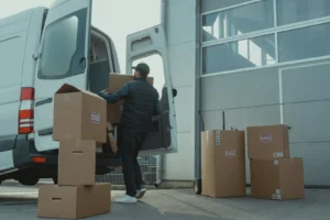 Delivery worker loading boxes into a van, representing how ERP for SMBs enhances logistics and supply chain efficiency.