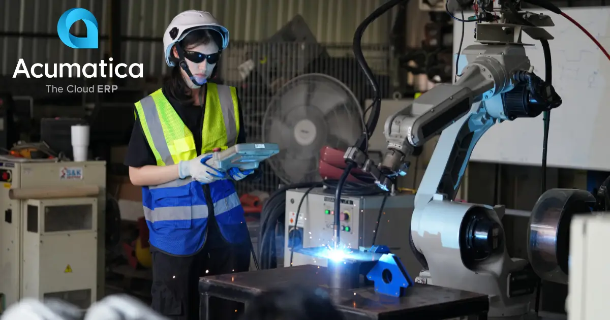 A small manufacturing business owner monitoring production processes in a workshop.