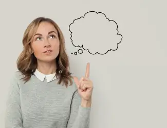 Thoughtful woman pointing upwards with a speech bubble above her, symbolizing decision-making and considering when to transition to an ERP system.